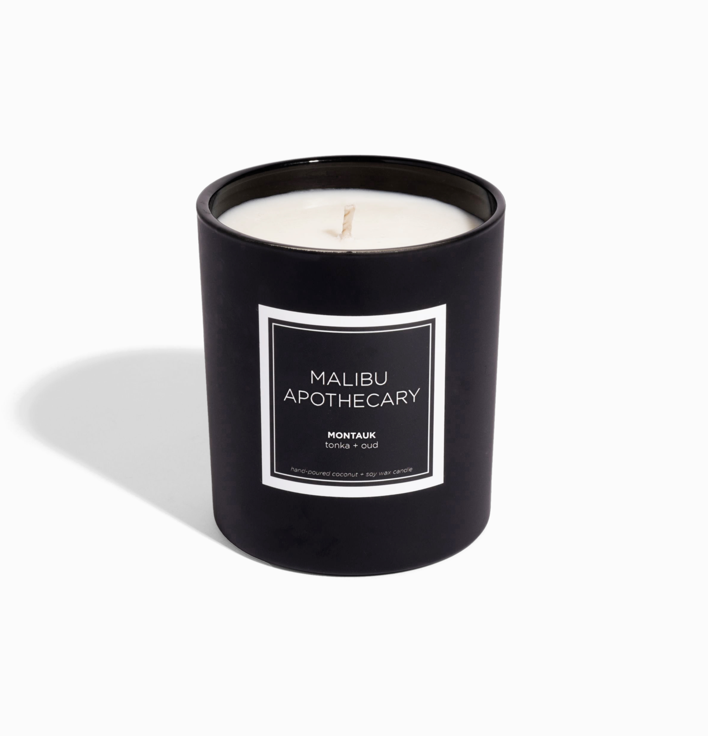 Matte black Malibu Apothecary candle in sleek black vessel with coconut and soy wax, pictured against a white background