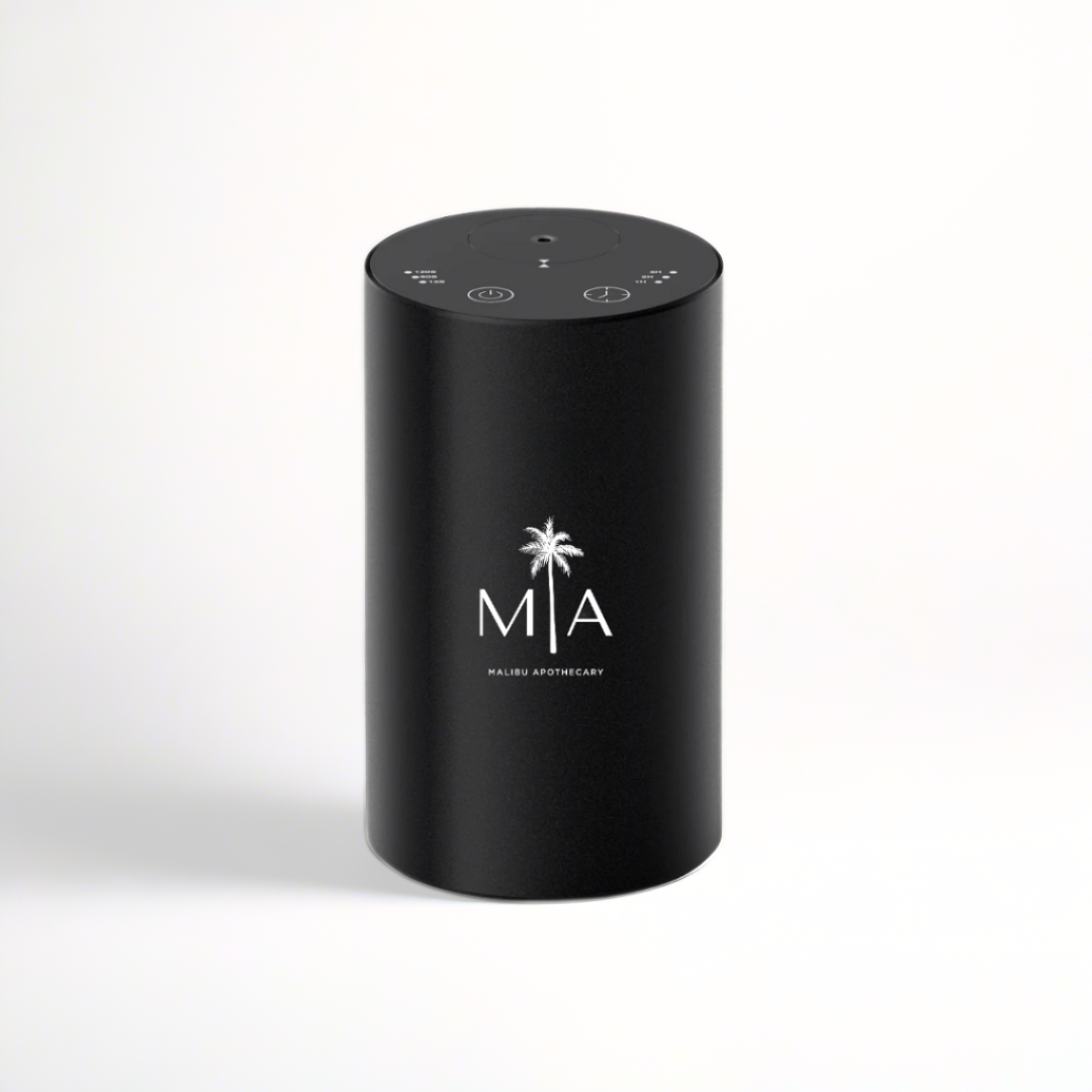 ScentSolution Mini mockup of portable black scent diffuser with white MIA logo, shown against a clean white background; depicts sleek cylindrical design and touch control icons for use with Malibu Apothecary pure aroma oils.