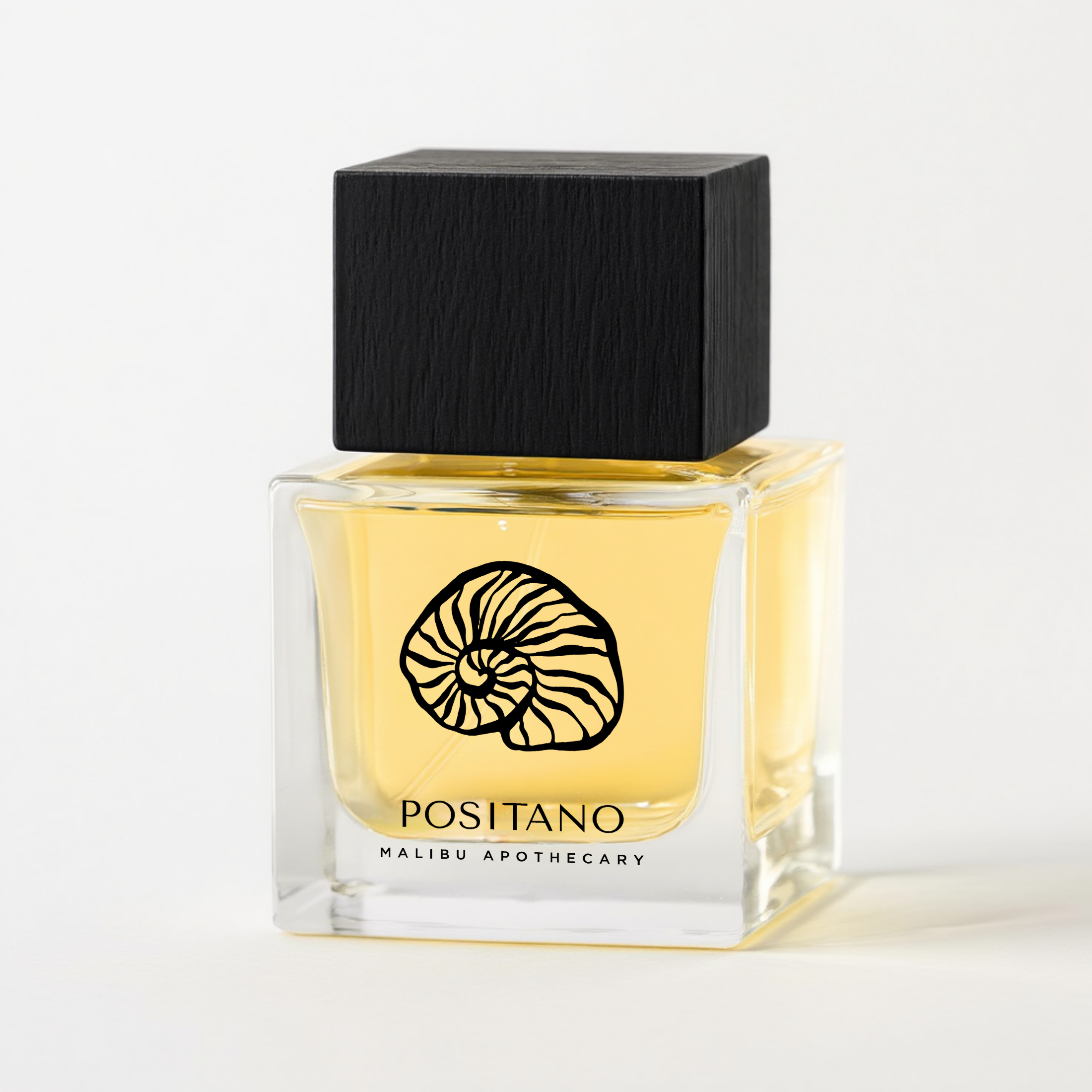Square glass perfume bottle with black wooden top of Malibu Apothecary Positano with yellow liquid, black square cap, and nautilus shell logo on a white background; luxury clean nontoxic custom perfume