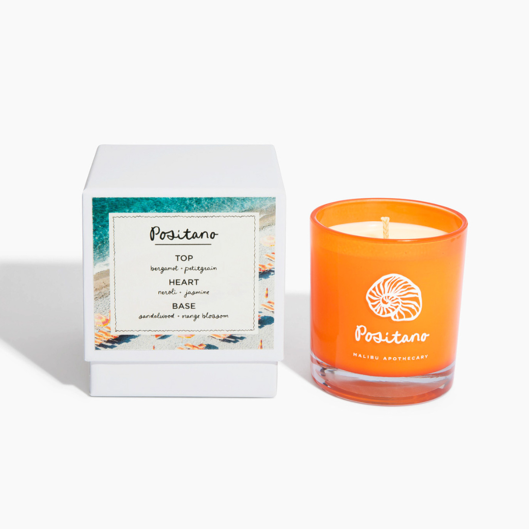 Positano candle with orange blossom and neroli scent next to its matching white box and fragrance note card, hand-poured with all natural coconut and soy wax