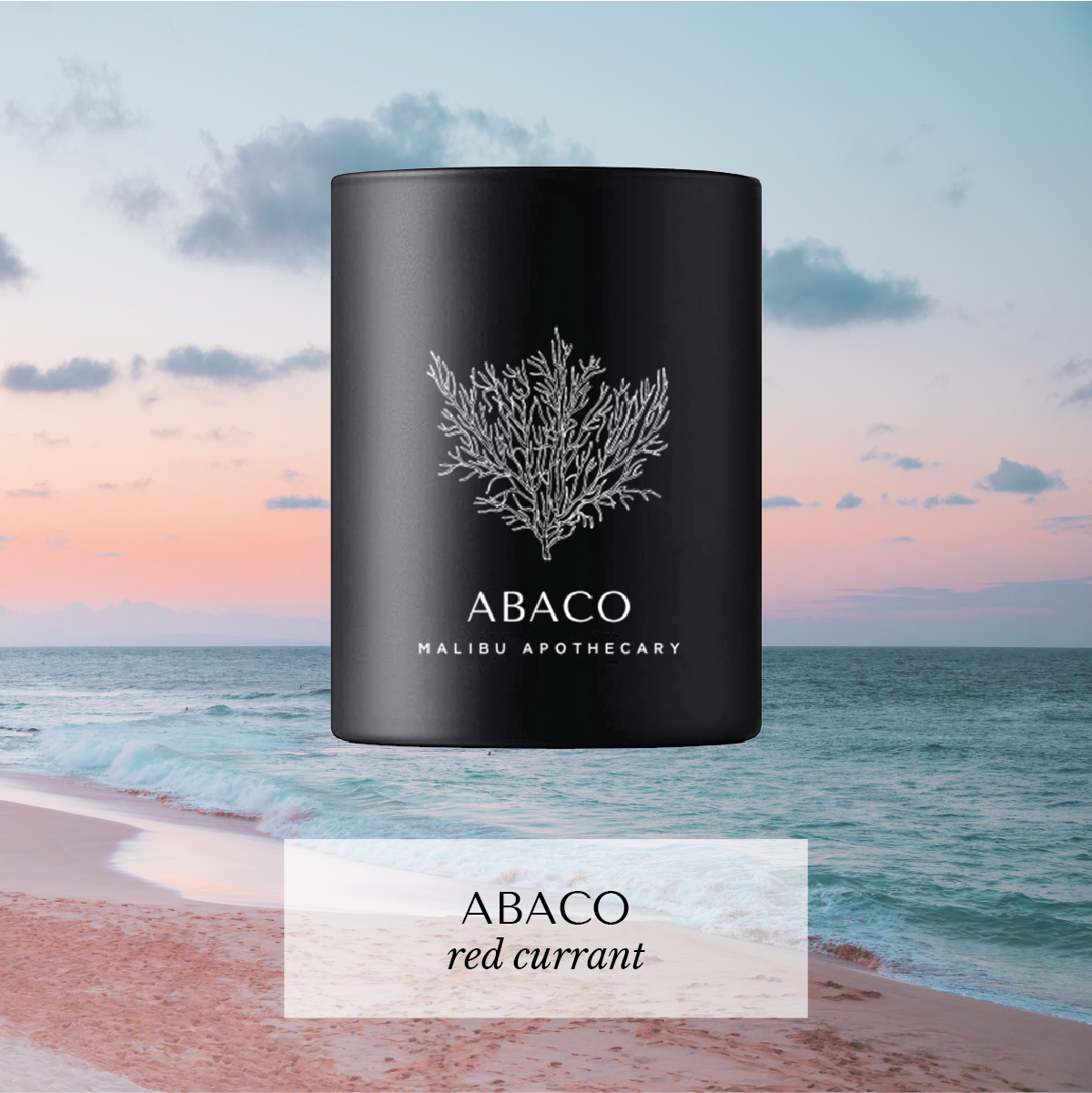 Abaco votive candle with coral icon and red currant scent against pastel sunset and turquoise ocean at pink sand beach, hand-poured with coconut and soy wax.