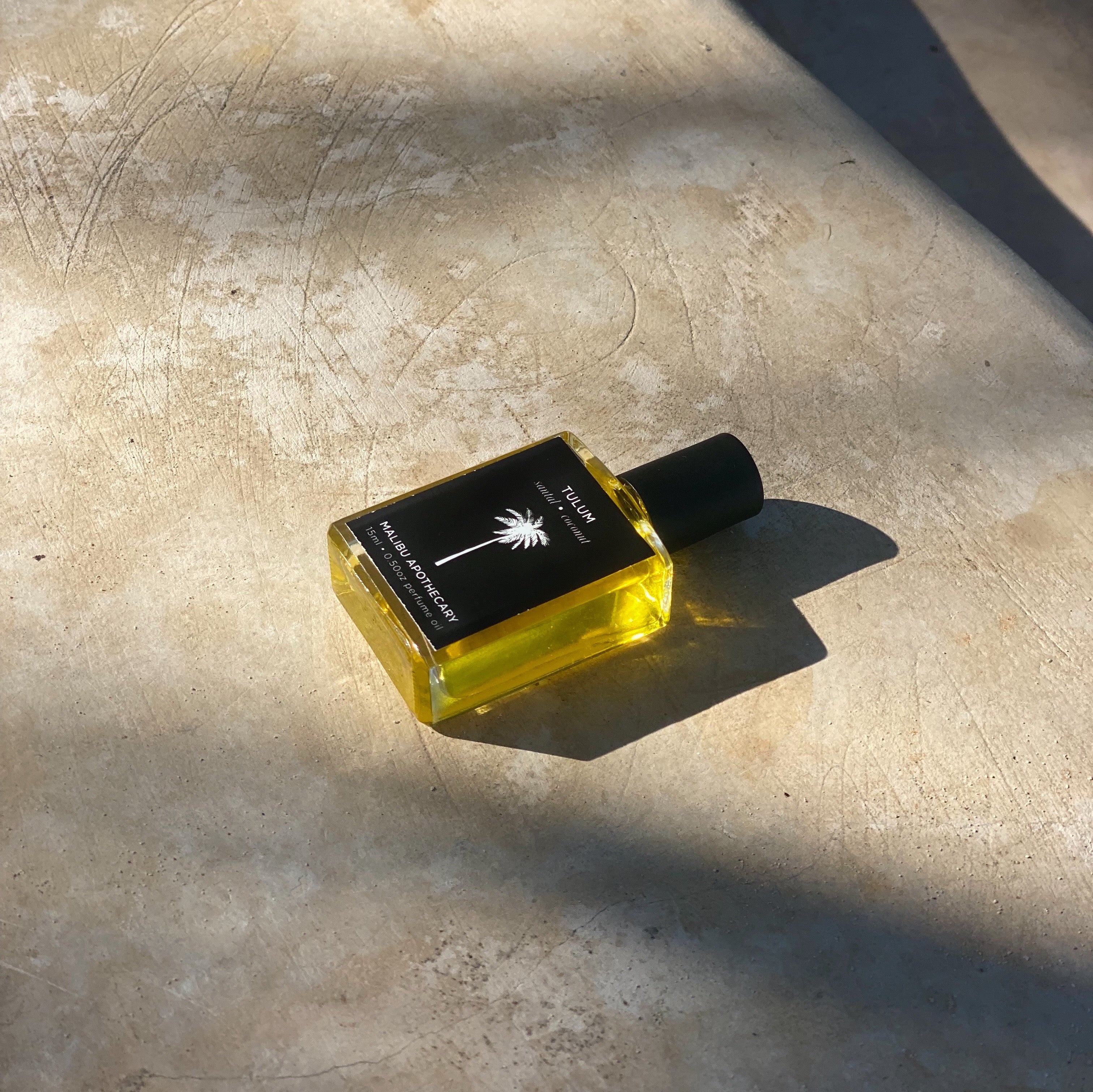 Roller Perfume created by Malibu Apothecary lying on concrete floor.