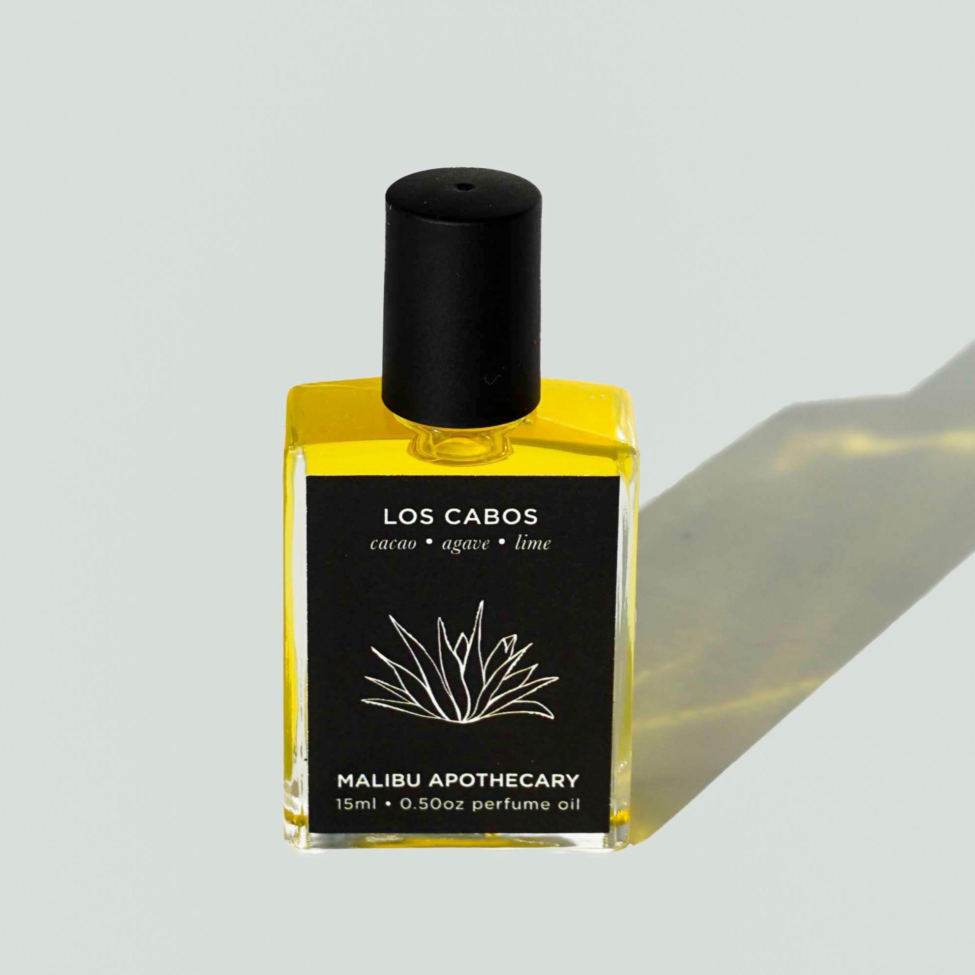 Los Cabos scented square roller perfume standing on white background with shadow. Notes of cacao, agave, lime