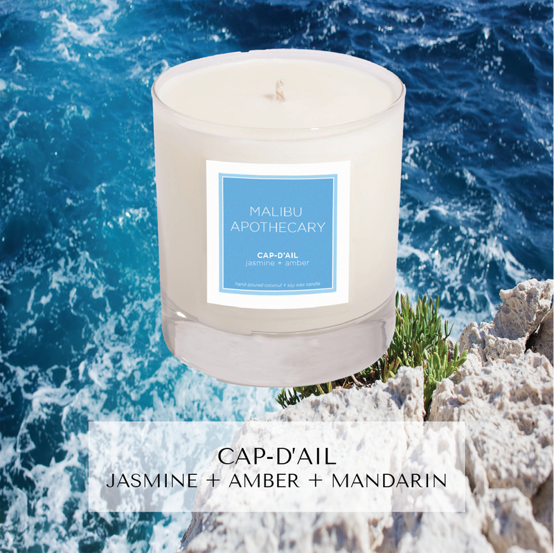 Clear gloss x blue candle in front of cliffside ocean in Mediterranean, in Cap-d'Ail near Monaco