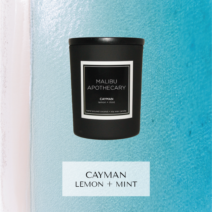 Mini black Malibu Apothecary candle labeled Cayman lemon + mint set against a turquoise aqua and white background reminiscent of Caribbean waters, made with all natural coconut and soy wax