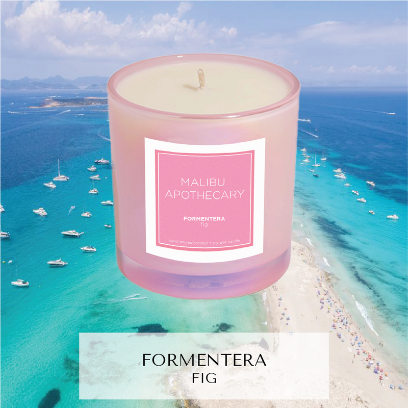 Iridescent Pink candle with notes of Fig reminiscent of Formentera, Spain sitting in front of beach 