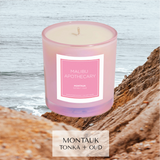 Montauk, Hamptons inspired candle with notes of tonka bean and oud sitting in front of cliffs on atlantic ocean 