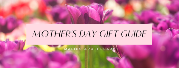 panoramic view of purple flowers behind a light pink banner with the title, "Mother's Day Gift Guide" written in black and underneath the logo, "Malibu Apothecary" written in white