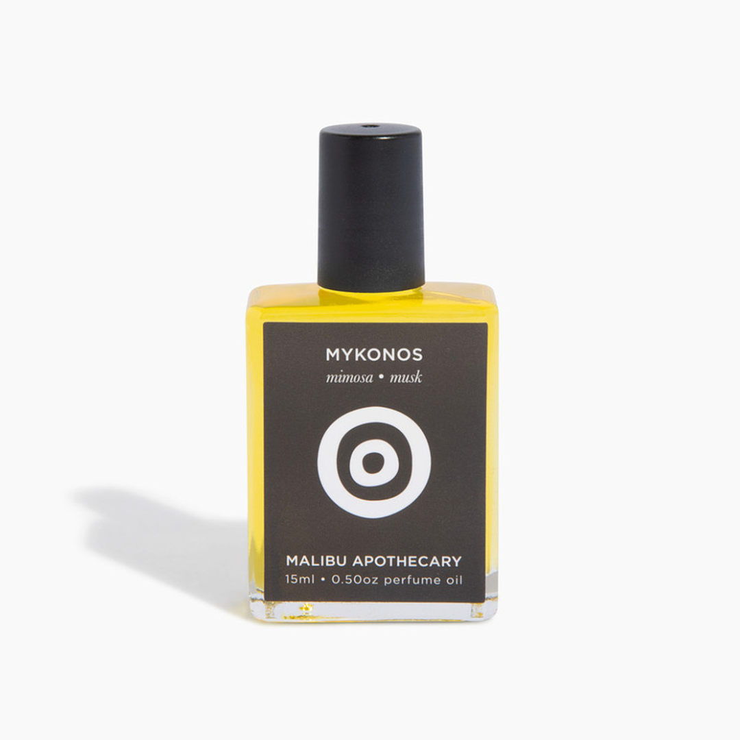 Soleil Roller Parfum bottle featuring Mykonos mimosa and musk scent in a chic yellow-tinted glass with black cap, infused with clean non-toxic fragrance oils and golden jojoba oil
