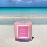 Iridescent Pink scented candle on white sand beach in Grace Bay, Turks & Caicos