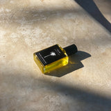 Roller Perfume created by Malibu Apothecary lying on concrete floor. 