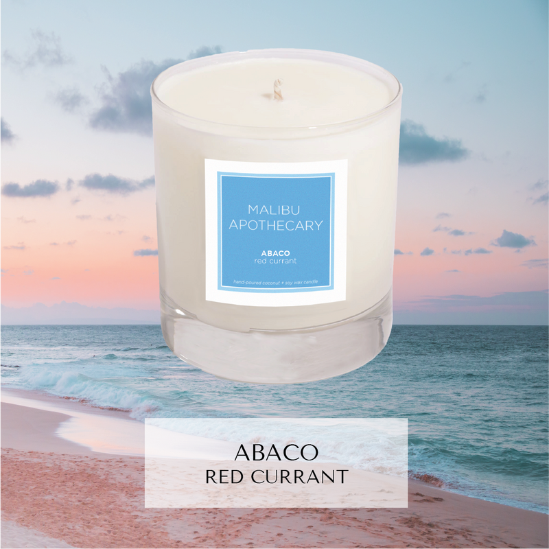 Abaco scented candle with notes of red currant in front of beach in the Bahamas