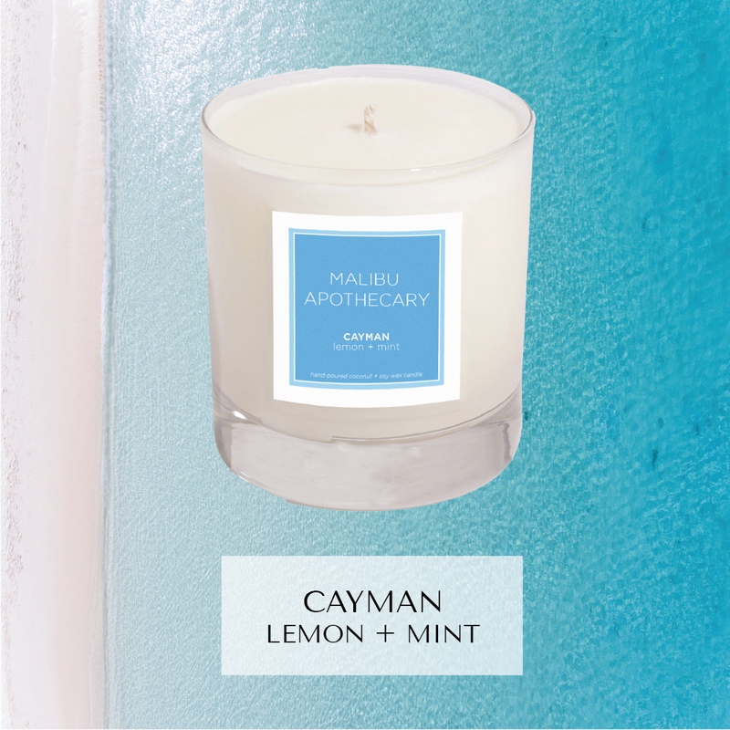 Cayman islands inspired fragrance with notes of lemon and mint in the Clear Gloss x Blue scented candle in front of Seven Mile Beach